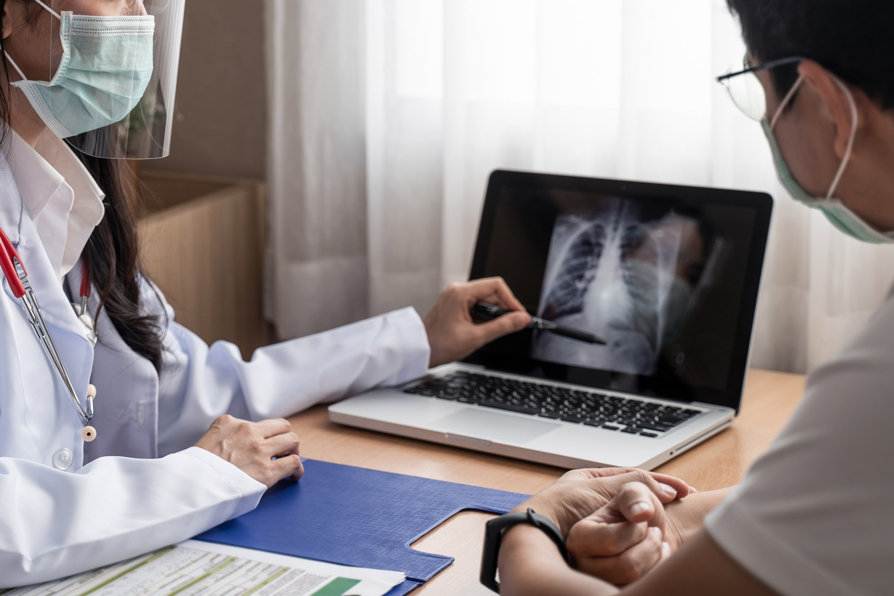 Doctor reviewing chest xray with patient