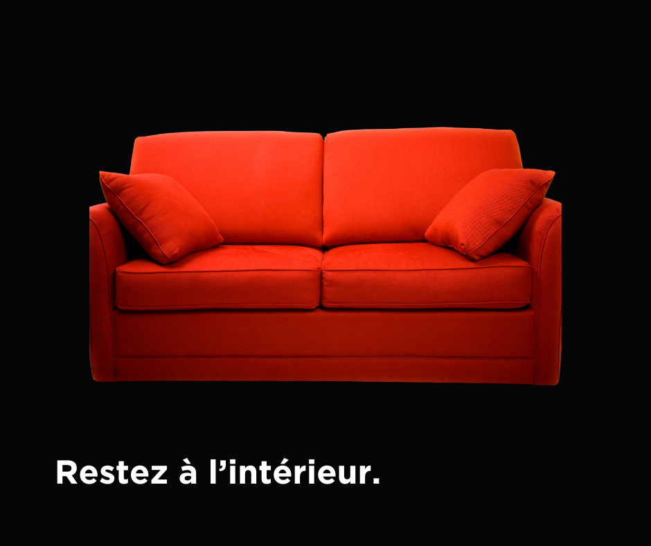 Red couch on black background with caption "Restez a l'interieur"