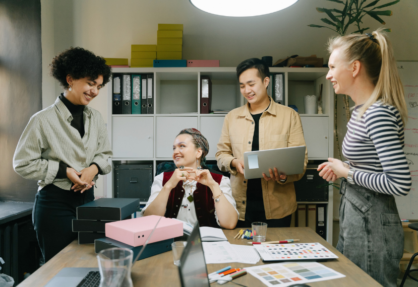 A group of office workers happily collaborating